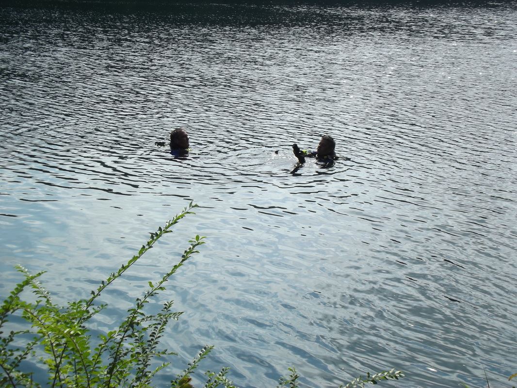 Two divers engaged in discussion during training sessions.