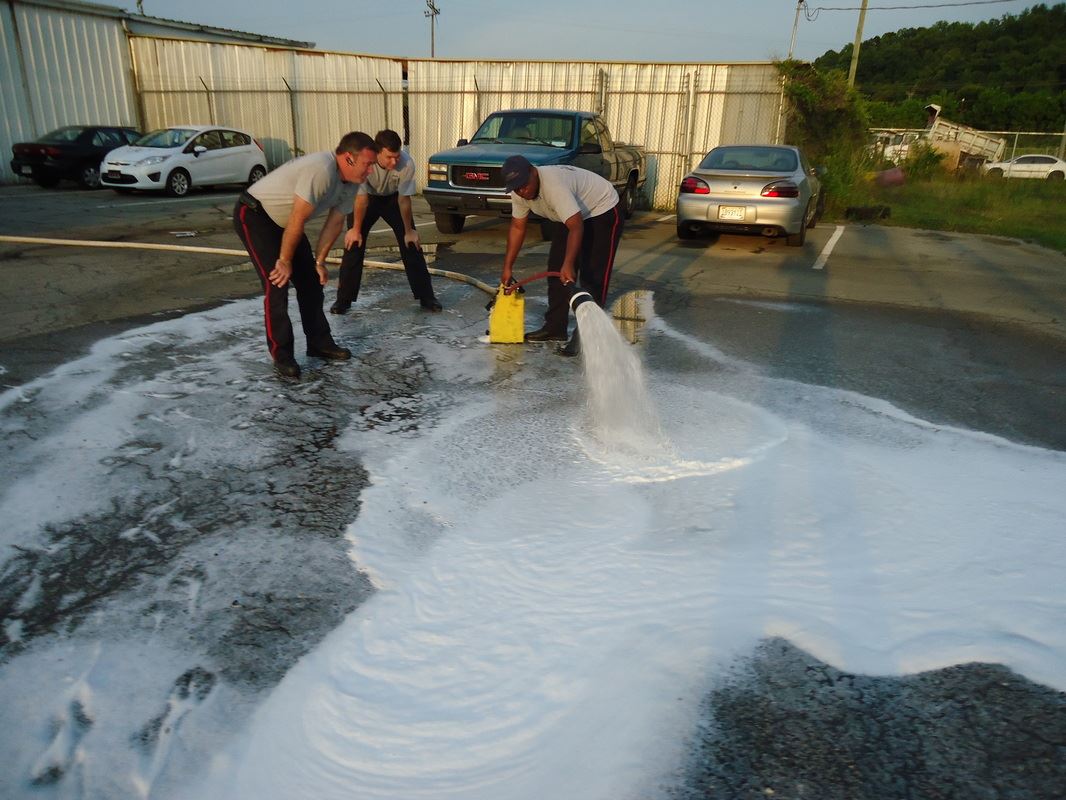 People Spreading Water on the Road